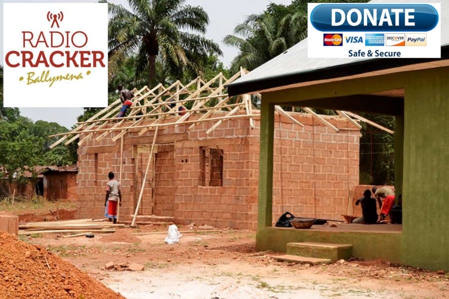 African local construction workers building a new brick house to roof level